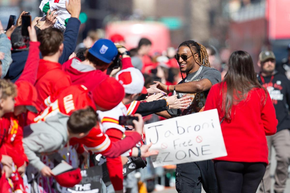 Kansas City Chiefs safety Justin Reid high fives fans during the Super Bowl Parade on Wednesday, Feb. 14 in Kansas City, Missouri.