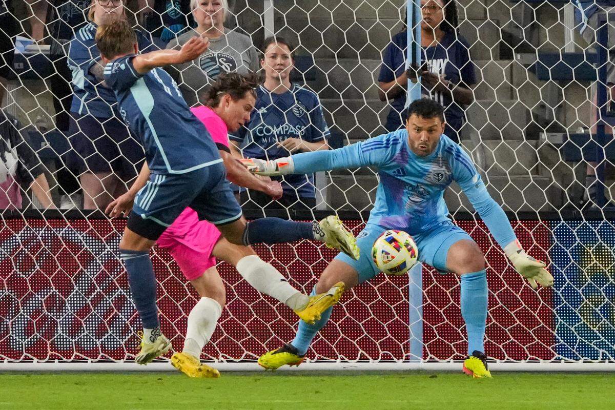 Sporting Kansas City goalkeeper John Pulskamp (1) prepares to block a shot on goal from Tulsa FC forward Phillip Goodrum (10) during the second half at Children’s Mercy Park on May 21, 2024.