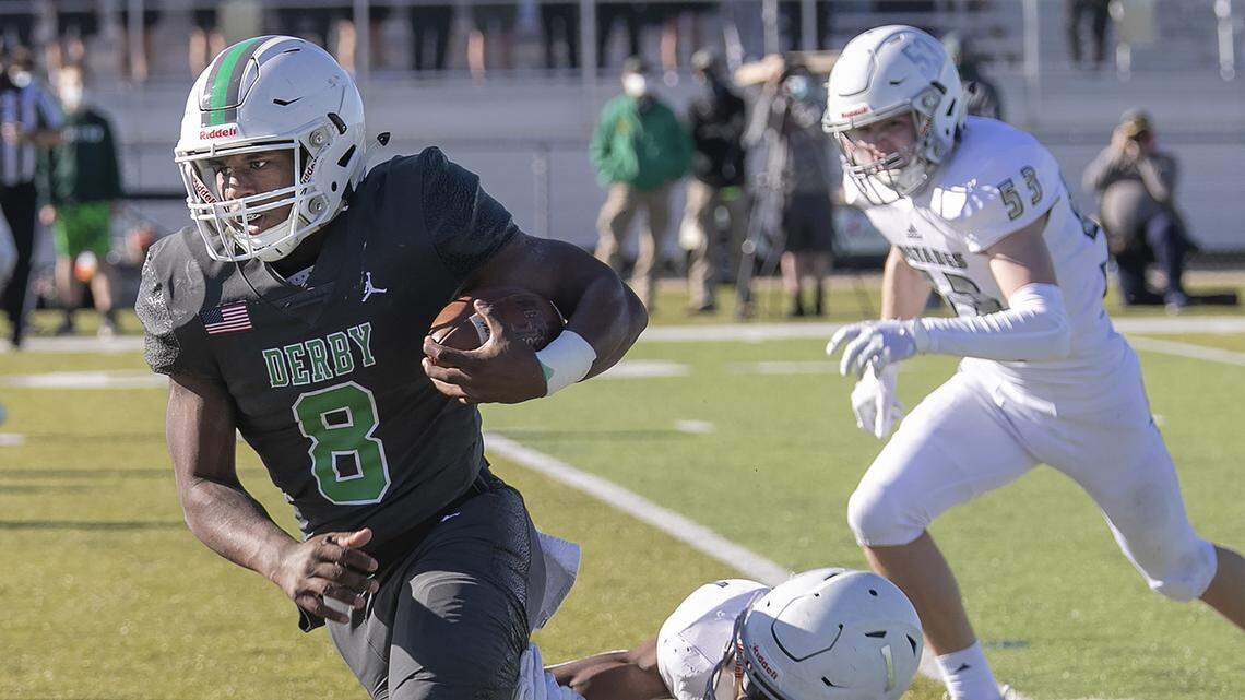 Derby quarterback Lem Wash avoids the Blue Valley North defense Saturday in the Kansas Class 6A state championship game at the College Boulevard Activity Center in Olathe.