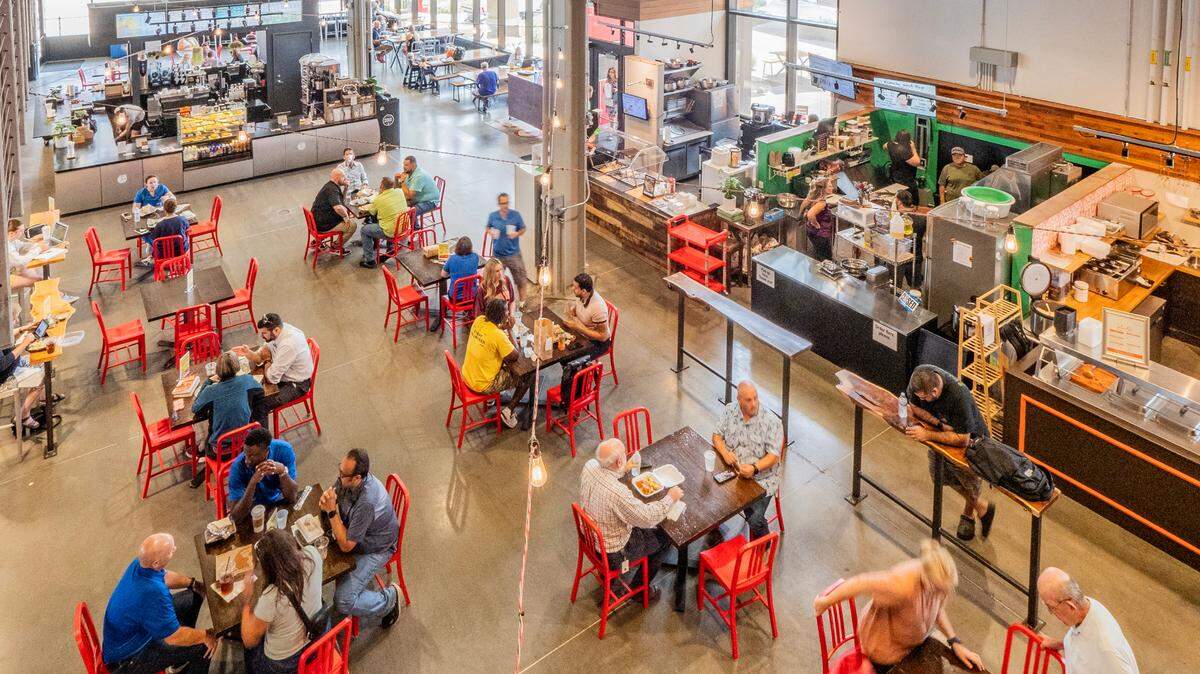 Families eat lunch at Lenexa’s Public Market, a food hall designed as a business incubator for restaurants and small, local businesses. 