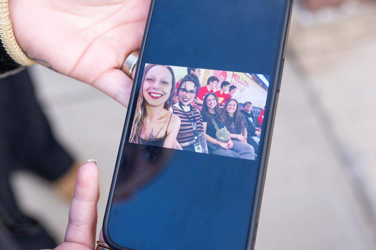 A photo of Jennifer Jensen with friends at a sporting event is shown to media outside Albert Riederer Community Justice Complex, on Monday, January 5, 2026. Jensen died in a car accident in Independence on December 27.
