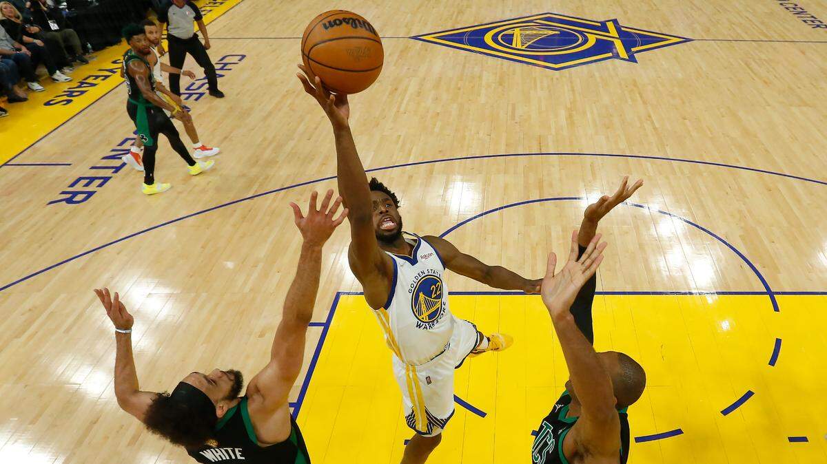 Golden State Warriors forward Andrew Wiggins, middle, shoots against Boston Celtics guard Derrick White, left, and center Al Horford during the first half of Game 5 of basketball’s NBA Finals in San Francisco, Monday, June 13, 2022. (AP Photo/Jed Jacobsohn, Pool)