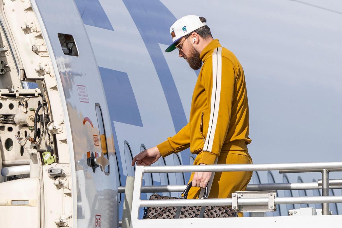 Kansas City Chiefs tight end Travis Kelce boards a United Airlines flight with teammates from Kansas City International Airport on Sunday, Feb. 2, 2025, traveling to New Orleans for Super Bowl LIX.