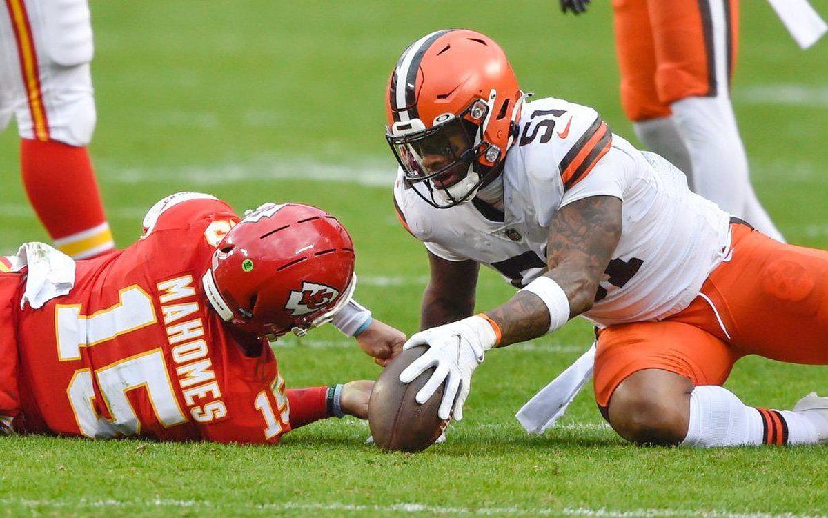 Kansas City Chiefs quarterback Patrick Mahomes lies on the ground after being hit by Cleveland Browns outside linebacker Mack Wilson in the third quarter Sunday, January 17, 2021, at Arrowhead Stadium in Kansas City, Missouri.Mahomes left the game after the play.