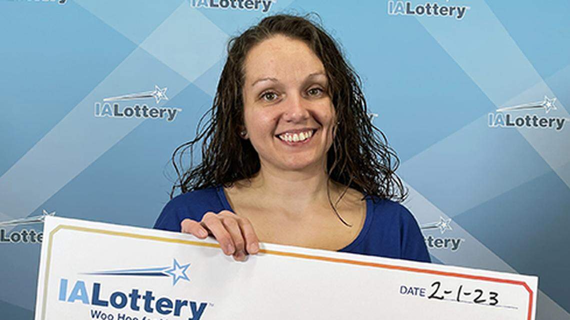 Jennyfer Akers shows her winning check.