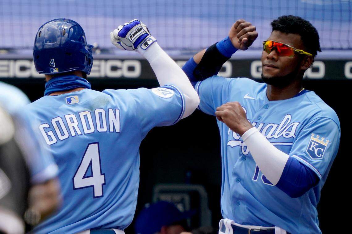 Kansas City Royals’ Alex Gordon (4) celebrates with Franchy Cordero after hitting a solo home run during the second inning of a baseball game against the Chicago White Sox Sunday, Aug. 2, 2020, in Kansas City, Mo. (AP Photo/Charlie Riedel)