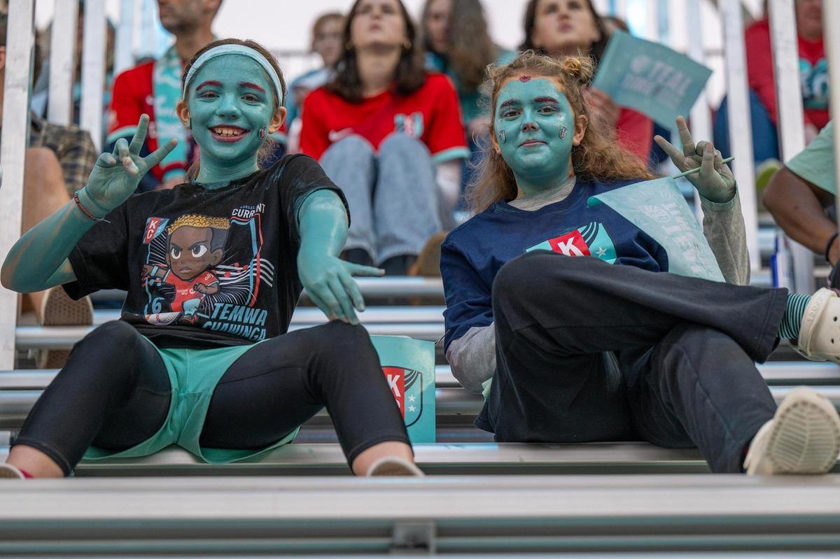 Ten-year-olds Dany Elrod, left, and Emery Carpenter show off teal face paint and red glitter eyebrows during a watch party at CPKC Stadium for the semifinal match between the Kansas City Current and Orlando Pride on Sunday, Nov. 17, 2024, in Kansas City.