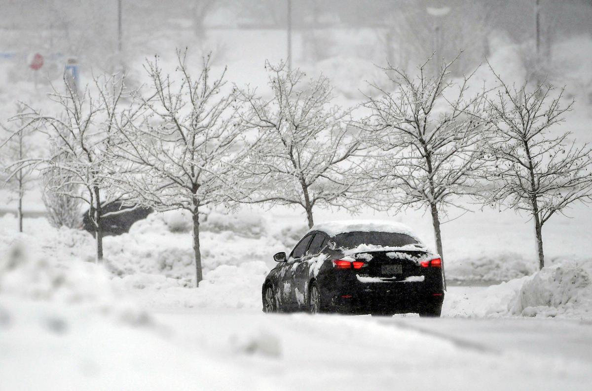 A vehicle navigated the snow-covered roads near Oak Park Mall on Tuesday, Jan. 9, 2024, after a winter storm dumped several inches of snow in the Kansas City area, including in Overland Park.