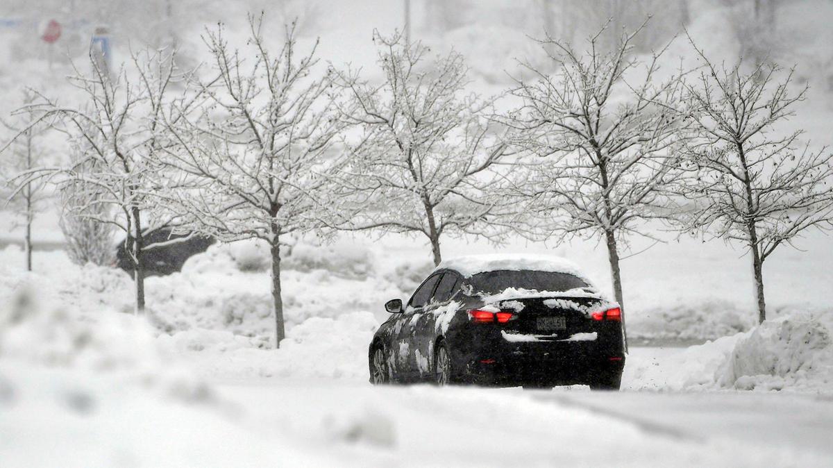 A vehicle navigated the snow-covered roads near Oak Park Mall on Tuesday, Jan. 9, 2024, after a winter storm dumped several inches of snow in the Kansas City area, including in Overland Park.