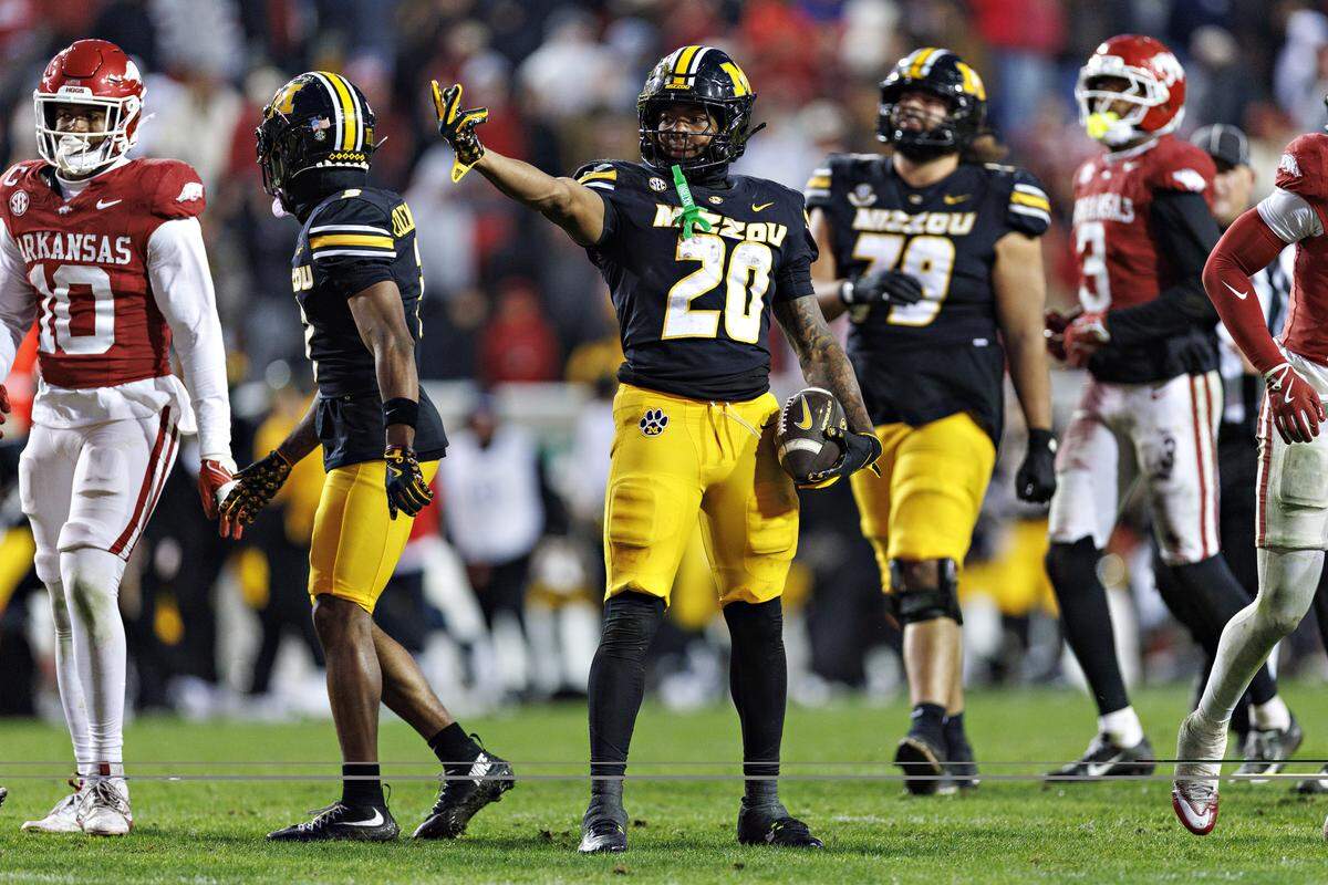 Jamal Roberts #20 of the Missouri Tigers signals first down in the second half during the game against the Arkansas Razorbacks at Donald W. Reynolds Razorback Stadium on November 29, 2025 in Fayetteville.