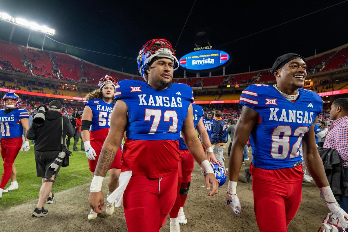 Kansas Jayhawks offensive lineman Dre Doiron (73) and wide receiver Isreal Moses V (82) leave the field after defeating the Colorado Buffaloes 37-21 at GEHA Field at Arrowhead Stadium on Saturday, Nov. 23, 2024, in Kansas City.