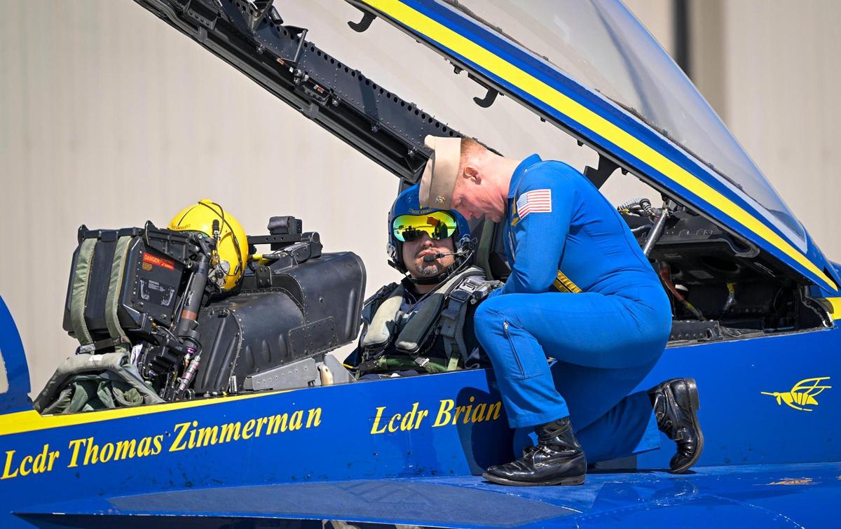 U.S. Navy Lt. Cmdr. Thomas Zimmerman, pilot, spoke with Erik Erazo, who was buckled in for a flight on the Blue Angels jet on Wednesday, Aug. 16, 2023, at New Century AirCenter in Gardner, Kansas. Erazo, an Olathe school district administrator who founded the district’s lowrider bike club, was selected as the Key Influencer for the 2023 Garmin KC Air Show was honored with a flight in an F/A 18 Super Hornet. “I only passed out once,” said Earzo, who briefly passed out when the aircraft hit 7 G’s.