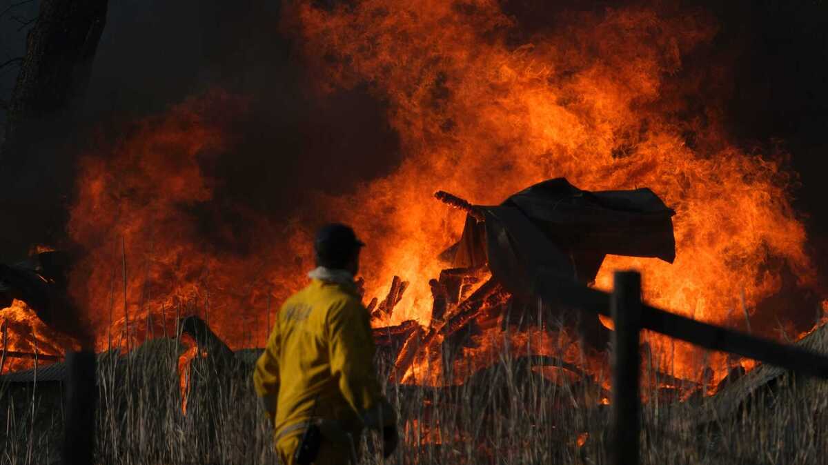 A home burns Saturday in the Corral Fire at Bernard and Stearman roads, west of Tracy. The wildfire exploded to more than 12,000 acres burned several structures and shut down an interstate freeway southwest of Tracy. Evacuation orders remain in place.