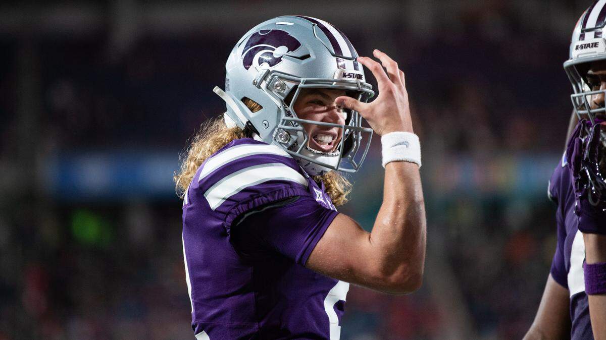 Kansas State quarterback Avery Johnson (2) celebrates his touchdown against NC State in the second quarter at Camping World Stadium in Orlando on Dec. 28, 2023.
