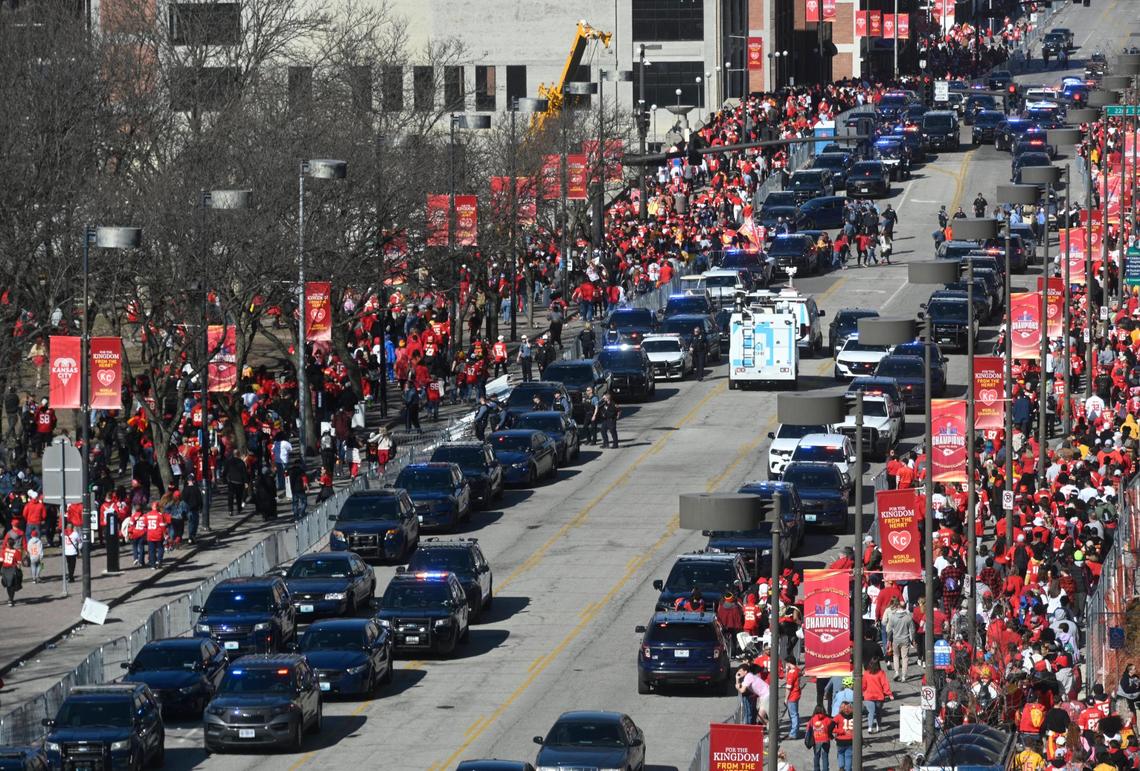 Crowds of people leave as law enforcement vehicles line Grand Boulevard after responding to a shooting at Union Station during the Kansas City Chiefs Super Bowl LVIII victory parade Wednesday, Feb. 14, 2024, in Kansas City.