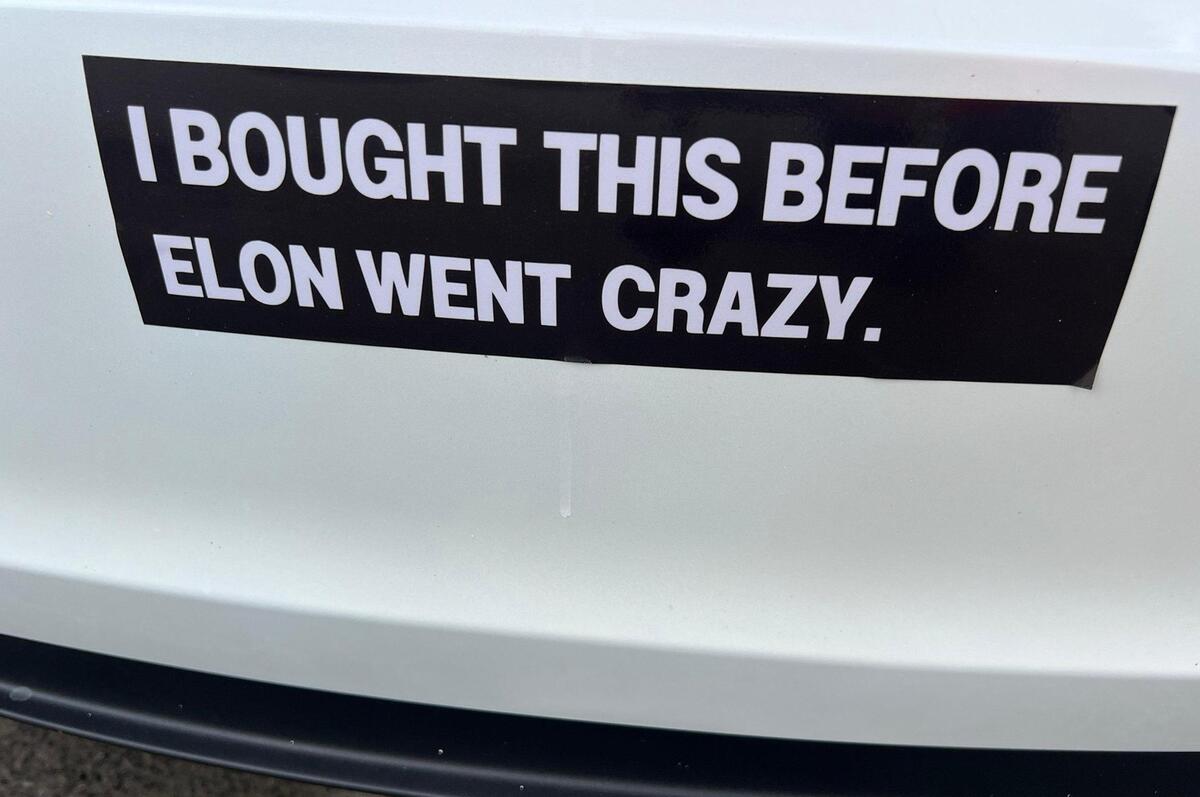 A bumper sticker on the back of a Tesla in Overland Park takes aim at Elon Musk, the company CEO and product architect.
