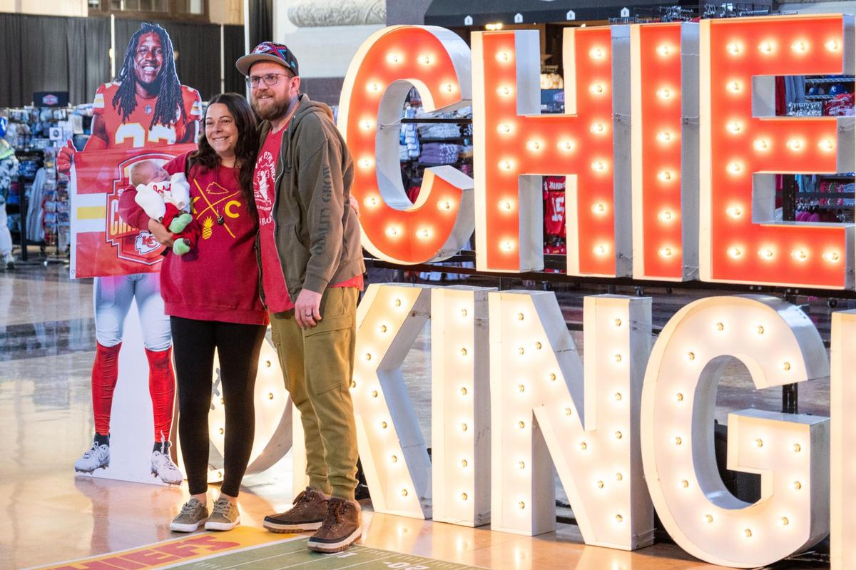 Kelly and Alex Wilson with their newborn, Rowan, took a photo at this year’s Chiefs Fan Zone at Union Station in Kansas City on Thursday, Jan. 16, 2025.