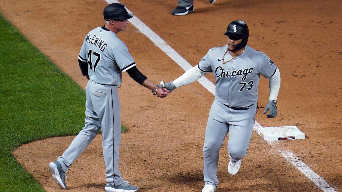 Chicago White Sox’s Yermin Mercedes, right, is congratulated by third base coach Joe McEwing after his home run off Minnesota Twins’ Willians Astudillo in the ninth inning of a baseball game, Monday, May 17, 2021, in Minneapolis. (AP Photo/Jim Mone)