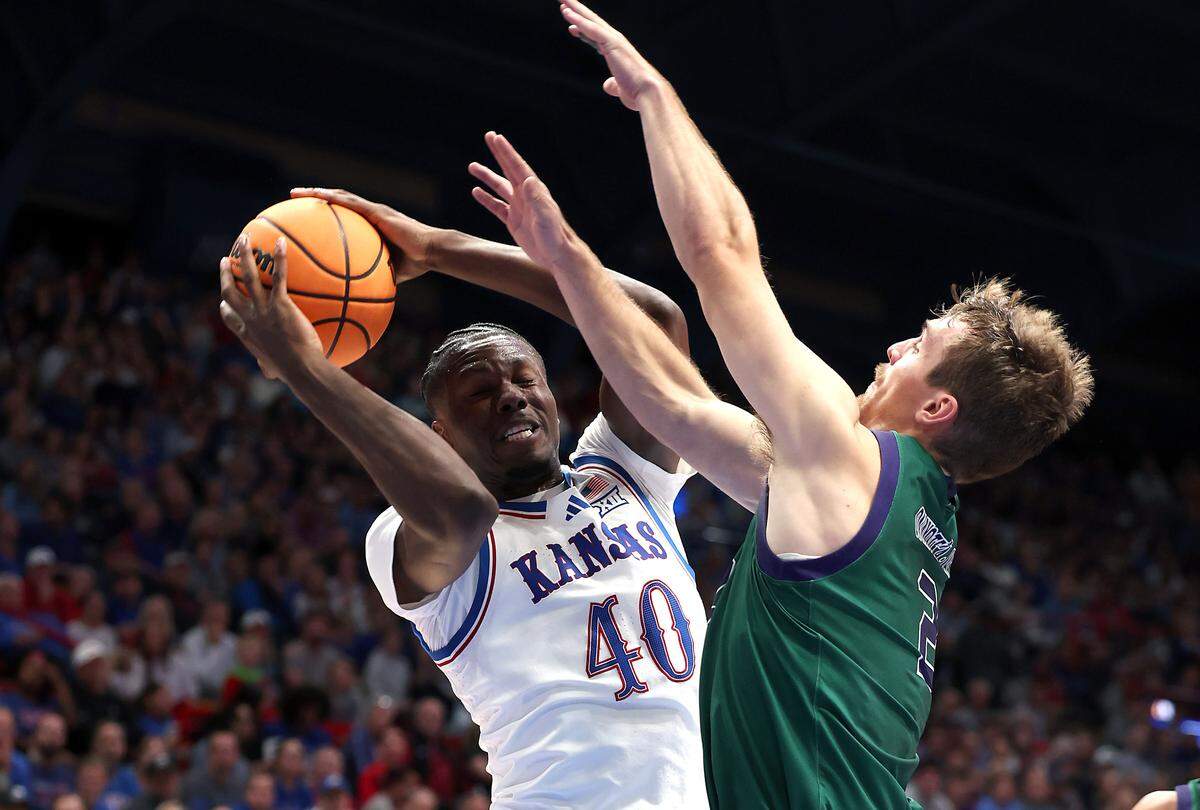 Forward Flory Bidunga #40 of the Kansas Jayhawks drives to the basket as guard Preston Ruedinger #2 of the Green Bay Phoenix defends during the first half of the game at Allen Fieldhouse on November 3, 2025 in Lawrence.