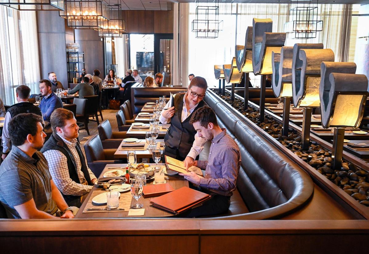 Server Gennilyn Eckard talks with diners during a soft opening Wednesday at Ocean Prime, a new modern American restaurant featuring seafood and steaks at 4622 Pennsylvania Ave.