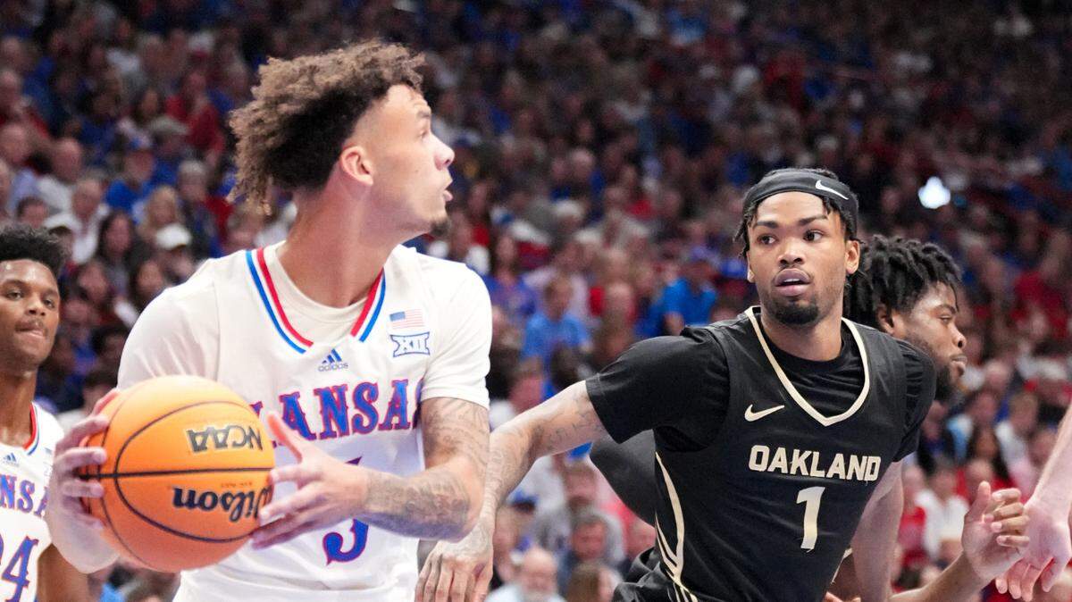 Kansas Jayhawks guard Zeke Mayo (5) looks to pass as Oakland Golden Grizzlies guard Jaylen Jones (1) defends during the first half at Allen Fieldhouse on Nov. 16, 2024.