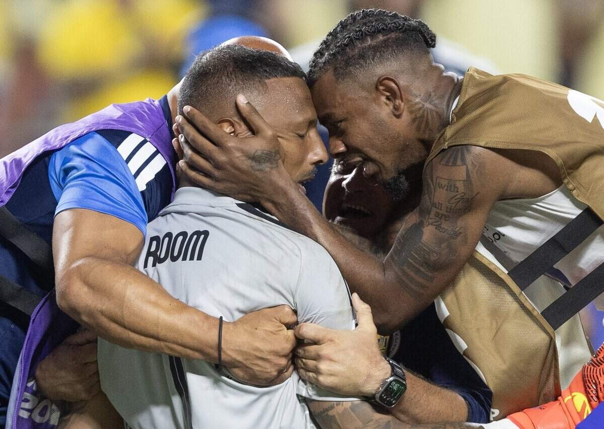 Curaçao players mob goalkeeper Eloy Room after he held Ecuador to a draw at a FIFA World Cup group-stage soccer match at Kansas City (Arrowhead) Stadium in Kansas City on Saturday, June 20, 2026.