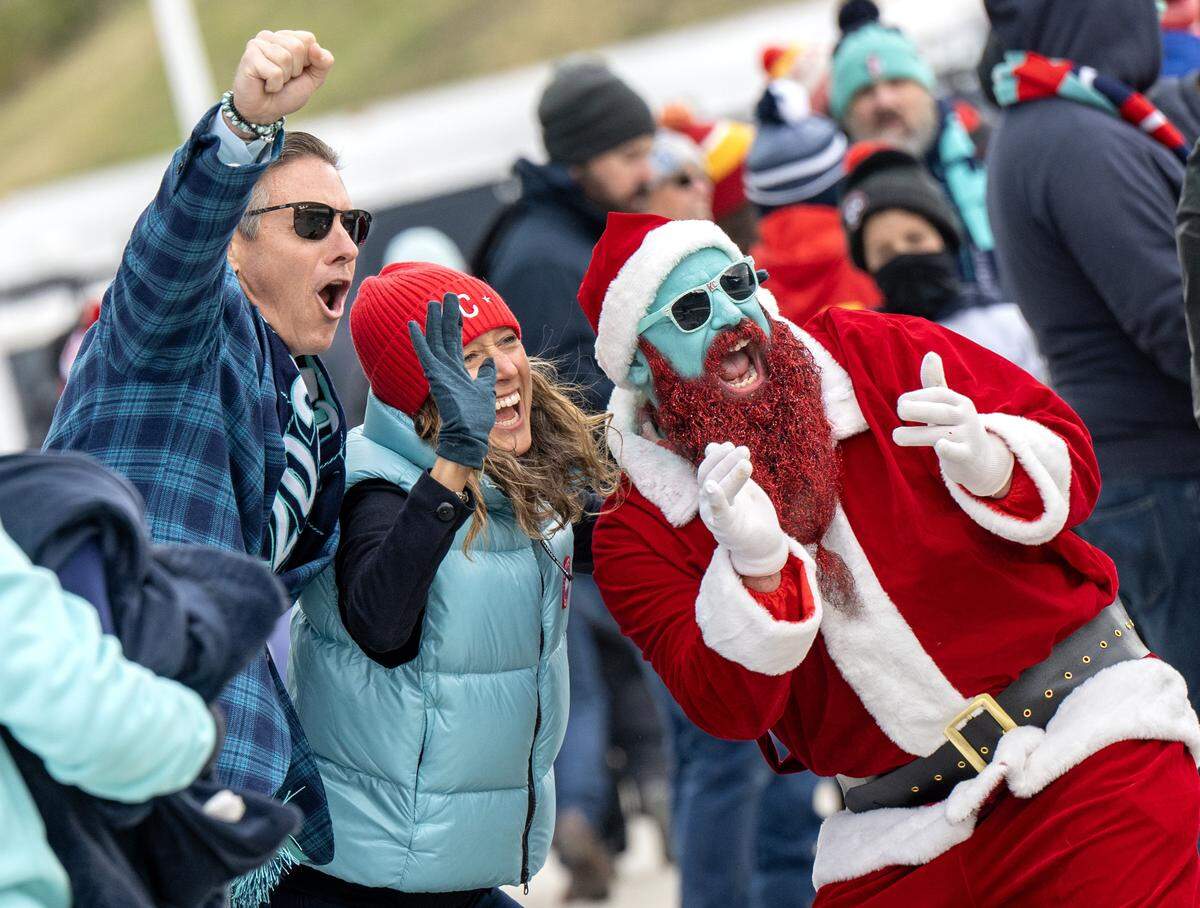 KC Current owners Chris and Angie Long cheer with Richard Harper, dressed as Santa Claus, before an NWSL playoff game against Gotham FC at CPKC Stadium in Kansas City on Sunday, Nov. 9, 2025.