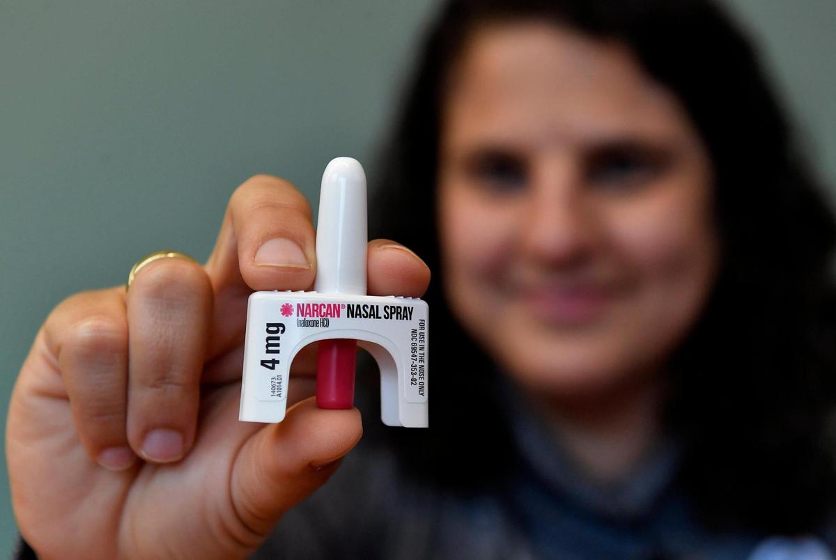 Mirna Herrera, special projects coordinator at University Health in Kansas City, holds a bottle of Narcan nasal spray that can be used to revive someone suffering an opioid overdose. With fentanyl overdoses rising among young people, more school districts are stocking the overdose medication and training staff how to use it.