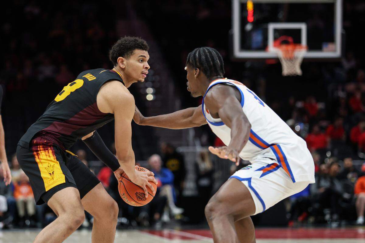 Florida Gators center Rueben Chinyelu (9) plays defense against Arizona State Sun Devils forward Basheer Jihad (8) during the second half at State Farm Arena in Atlanta on Dec. 14, 2024.