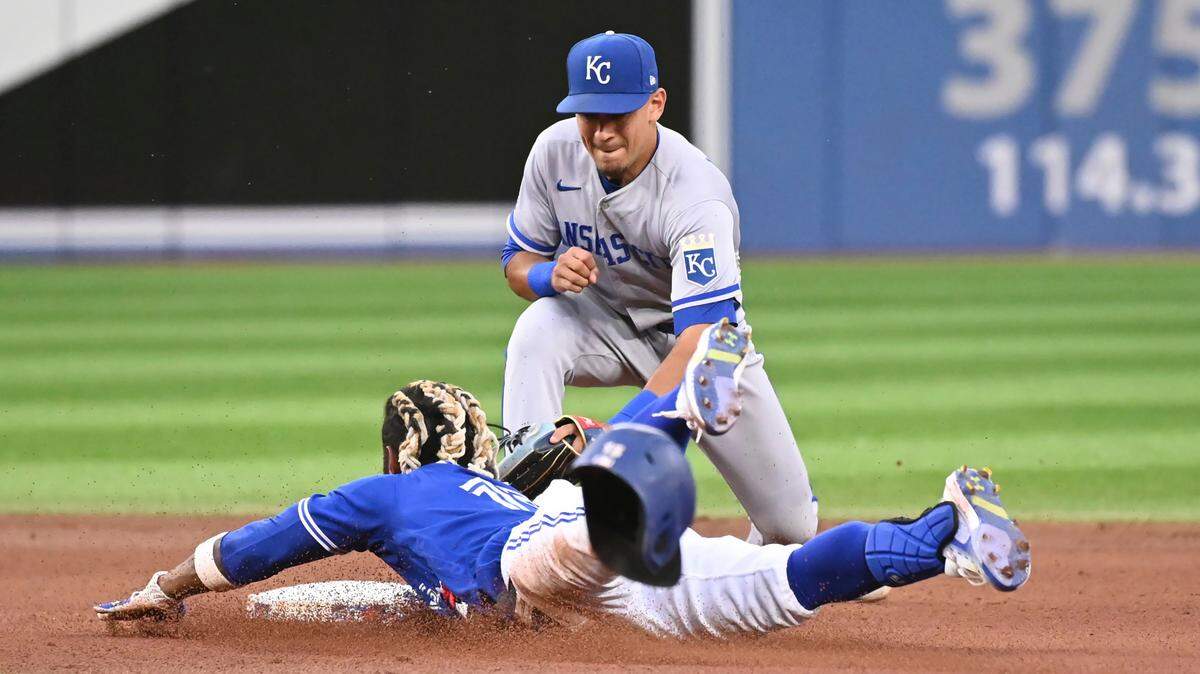 Toronto Blue Jay’ Raimel Tapia, bottom, is tagged out by Kansas City Royals second baseman Nicky Lopez while attempting to stretch a single into a double during the fourth inning of a baseball game Friday, July 15, 2022, in Toronto. (Jon Blacker/The Canadian Press via AP)