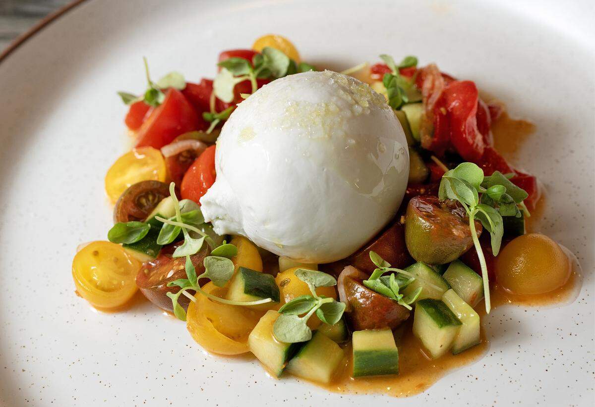 Burrata with heirloom tomato, cucumber and basil is on the menu at Palm Beach Club, a restaurant and bar featuring coastal vibe dinning. The restaurant is opening this month in Kansas City's Power &amp;amp;amp; Light District.