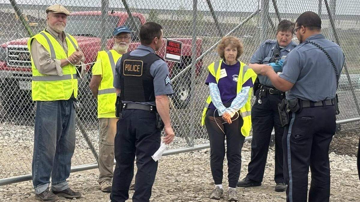 Three anti-nuclear weapons demonstrators under arrest on Monday near the Kansas City National Security Campus.
