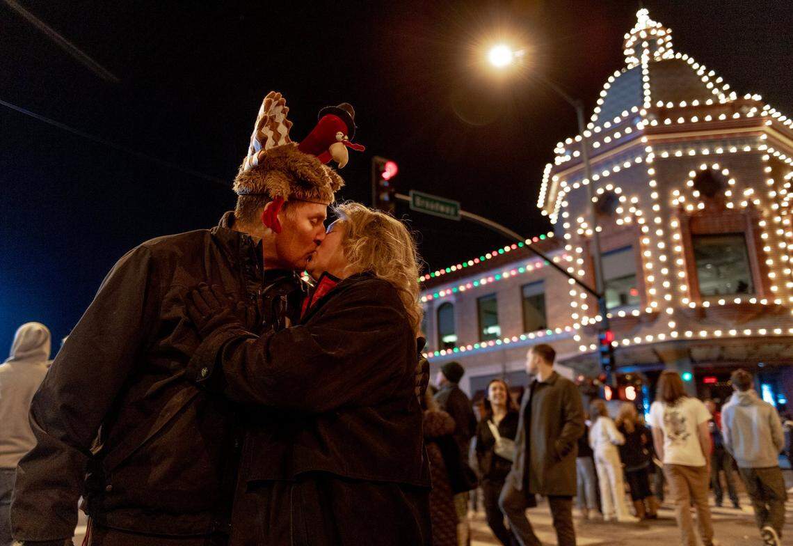 Patty Scholten of Garden City, Missouri, kisses her husband Chris after holiday lights were switched on at the Country Club Plaza during the 93rd annual Thanksgiving night lighting ceremony.