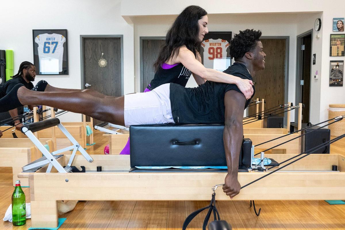 Kahley Schiller, a certified pilates instructor, instructs Truman Jones, a defensive end on the Chiefs’ practice squad, on his pilates work out on Tuesday, Oct. 29, 2024, at Pilates By Kahley in Overland Park.