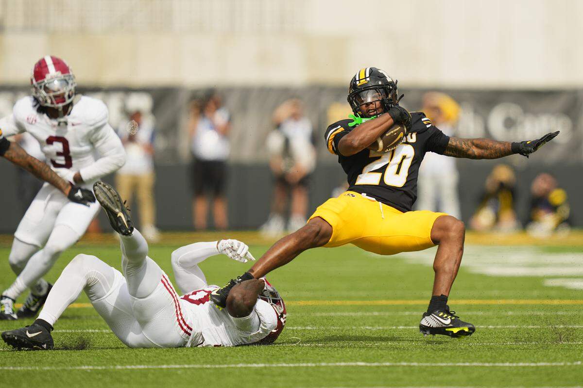 Missouri Tigers running back Jamal Roberts (20) is brought down by Alabama Crimson Tide linebacker Justin Jefferson (10) during the second half of the game at Faurot Field at Memorial Stadium on Oct. 11, 2025.