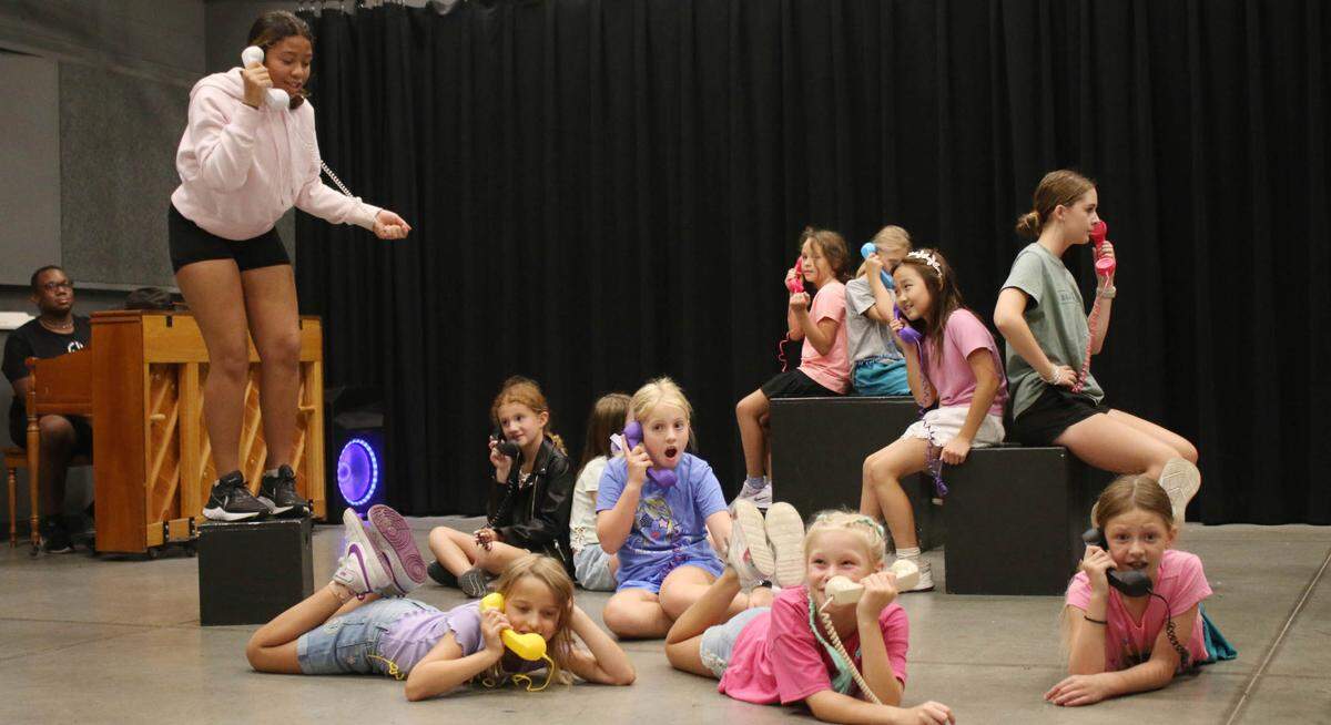 Charlotte McCormick, Violet Kraft, Dottie Keeton, Laila Bringman and Vivian Griffith, from left in the foreground, perform “The Telephone Hour” from “Bye Bye Birdie” as part of an ensemble during a Broadway workshop camp at the Johnson County Arts and Heritage Center.