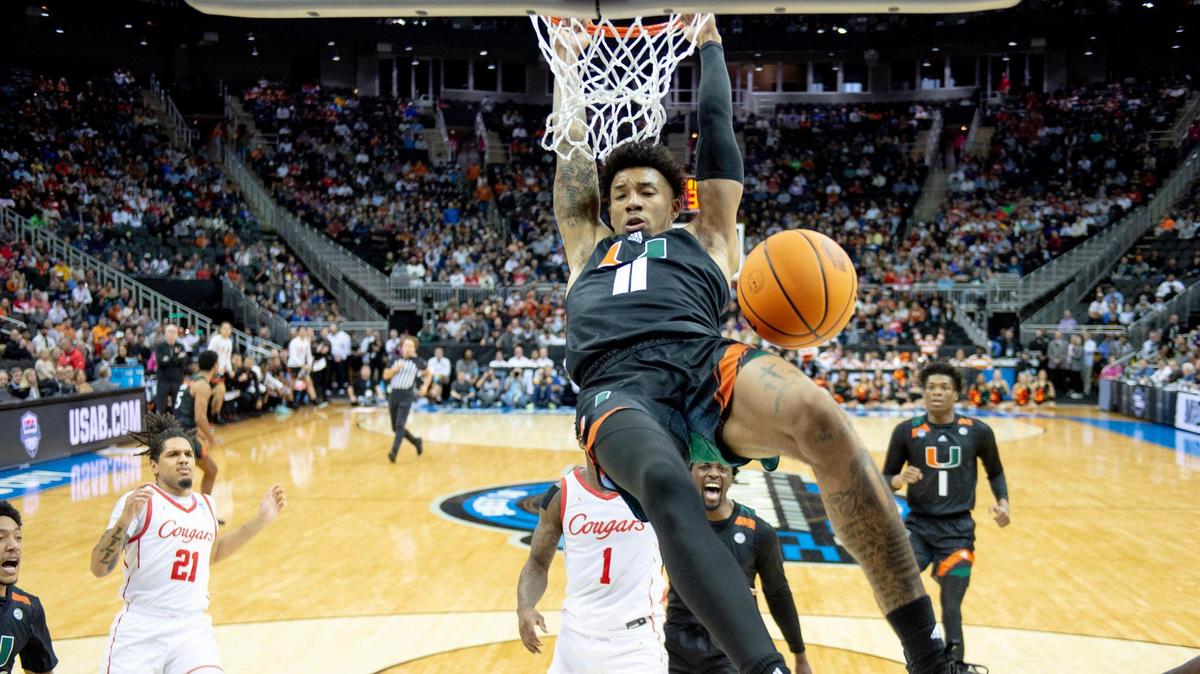 Miami guard Jordan Miller (11) hangs on the rim after dunking against Houston during a Sweet 16 game in the Midwest Regional of the NCAA Tournament Friday, March 24, 2023, in Kansas City.