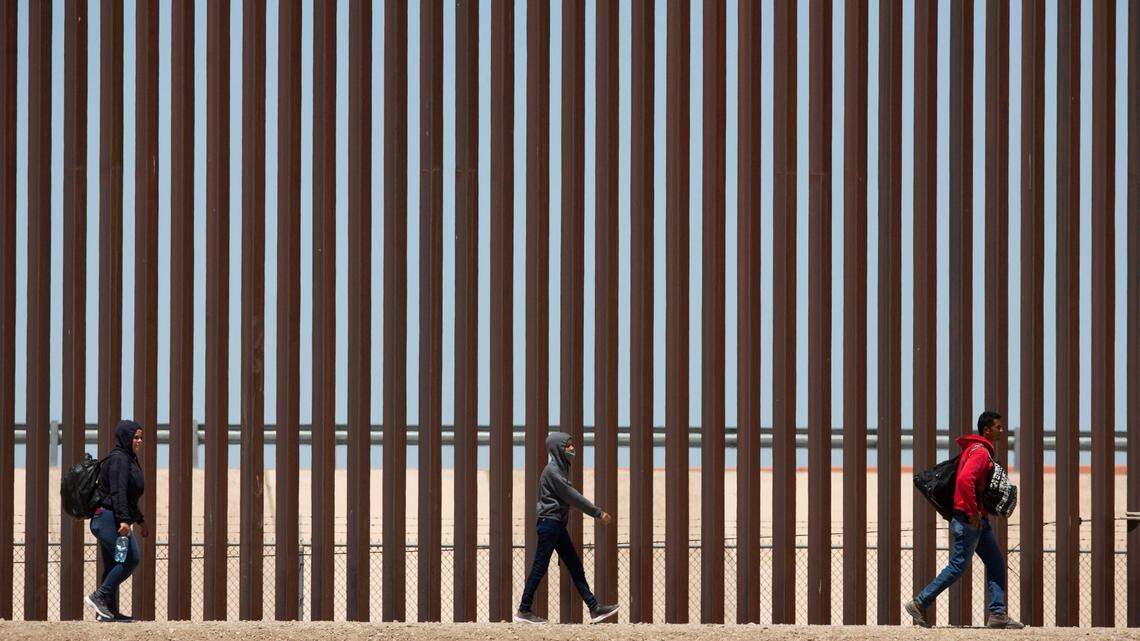 Migrants await to be processed at gate 40 of the border wall after having crossed the Rio Grande from Ciudad Juarez in hopes of turning themselves in with the intention of seeking asylum.