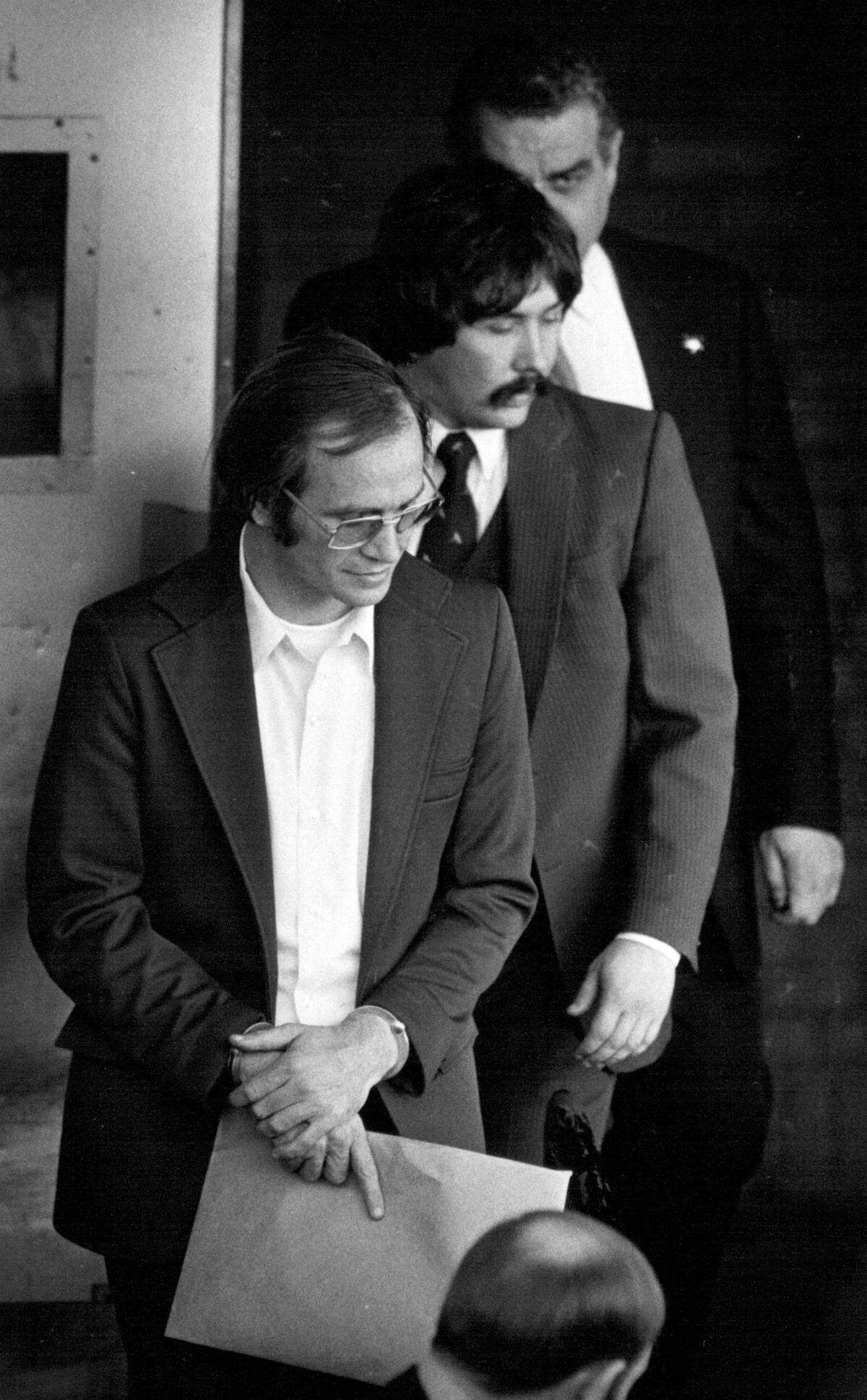 In 1983, U.S. marshals escorted James Lewis, front, out the rear door of the federal courthouse in Kansas City after he pleaded not guilty to charges of mail fraud in connection with an alleged credit card scheme and tax evasion.