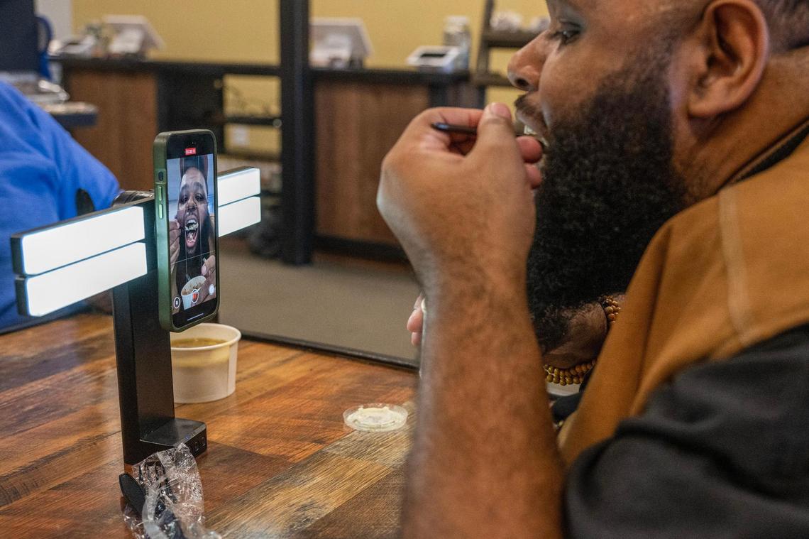 Glenn Robinson records himself trying shepherd’s pie for a food review video at The Upper Cut KC.