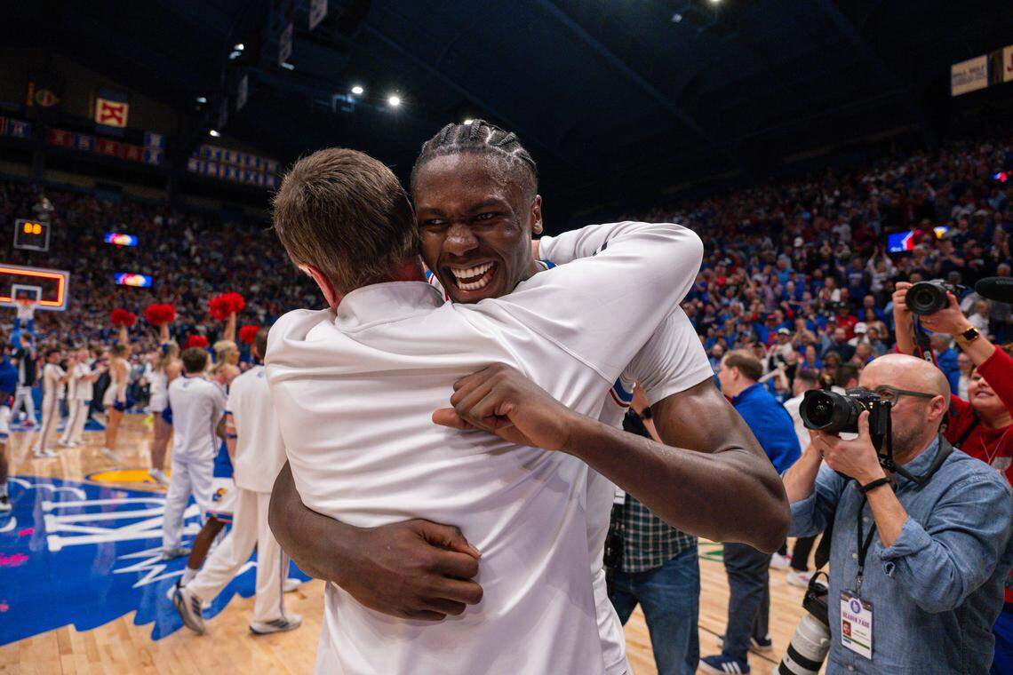Kansas Jayhawks forward Flory Bidunga (40) hugs head coach Bill Self on the court following the win vs. the Arizona Wildcats on Monday, February 9, 2026, at Allen Fieldhouse.