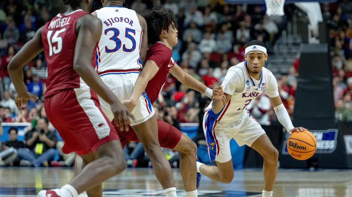 Kansas guard Dajuan Harris Jr. (3) dribbles as forward Zuby Ejiofor (35) sets a screen on Arkansas guard Anthony Black (0) during a second-round college basketball game in the NCAA Tournament Saturday, March 18, 2023, in Des Moines, Iowa.
