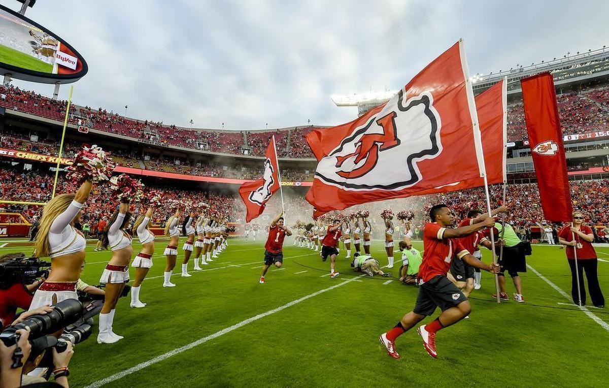 Cheerleaders lead the Kansas City Chiefs players on to the field before the start of a game against the Seattle Seahawks on August 21, 2015 at Arrowhead Stadium.