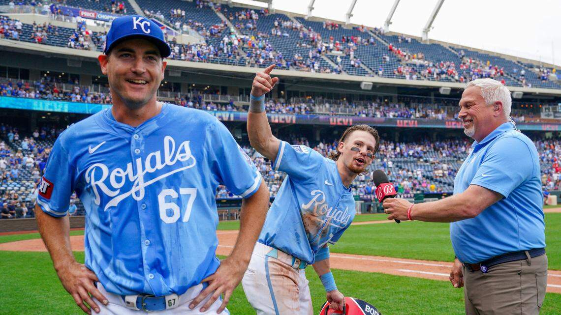 Kansas City Royals shortstop Bobby Witt Jr. (7) speaks to Bally Sports announcer Joel Goldberg, leading fans in a “Let’s go Lugo” chant, as starting pitcher Seth Lugo (67) looks on after the win over the Chicago White Sox at Kauffman Stadium on July 21, 2024.