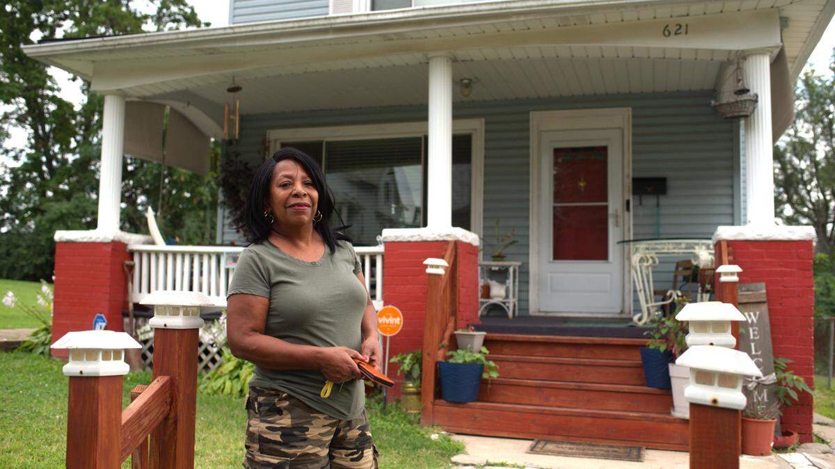 Vanessa Robinson, president of the Caring Neighborhood Association community group in northeast Kansas City, Kansas, stands for a portrait in front of her home Aug. 20, 2024. Robinson is among the neighborhood leaders concerned about some city and county budget cuts set to take effect next year, including to the Livable Neighborhoods office, a liaison between the neighborhoods and Unified Government of Wyandotte County and Kansas City, Kansas.