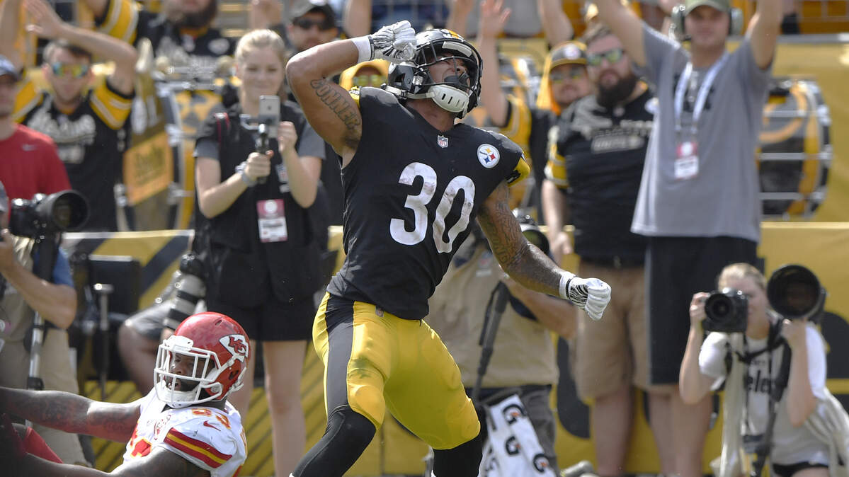 Pittsburgh Steelers running back James Conner celebrated scoring a two point conversion with 18 seconds left in the first half past the defense of Kansas City Chiefs linebacker Anthony Hitchens during the game Sunday, September 16, 2018, at Heinz Field in Pittsburgh, Pa. The game was tied up at halftime after the Chiefs took an early lead.