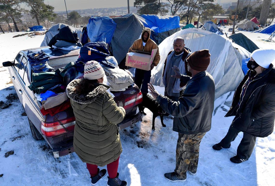 As winter settles in and temperatures drop dramatically, survival for the homeless becomes more difficult. On Monday afternoon at a well established camp on the northeast side of downtown, a man who gave his name as Jimmy, gestured as he spoke with residents there. He and a friend stop by the camp at least once a week with donations.