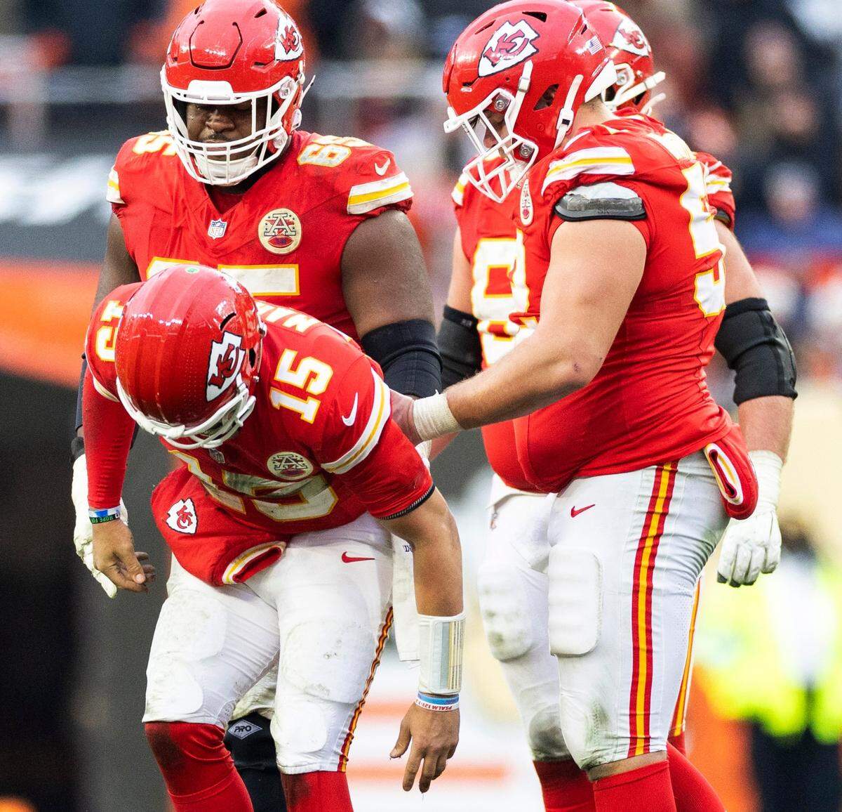 Kansas City Chiefs teammates surround quarterback Patrick Mahomes as he limps off the field with help late in a Week 15 game against the Cleveland Browns at Huntington Bank Field in Cleveland, Ohio on Sunday, Dec. 15, 2024.