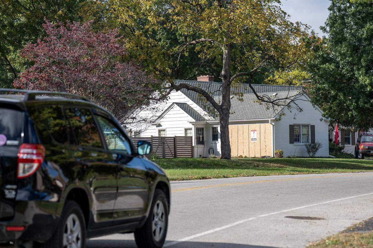 A car passes the home of former Independence Mayor Eileen Weir on Blue Ridge Boulevard on Thursday, Oct. 30, 2025, in Independence. The house was struck by a truck earlier in the week, injuring Weir and her husband, Tom.