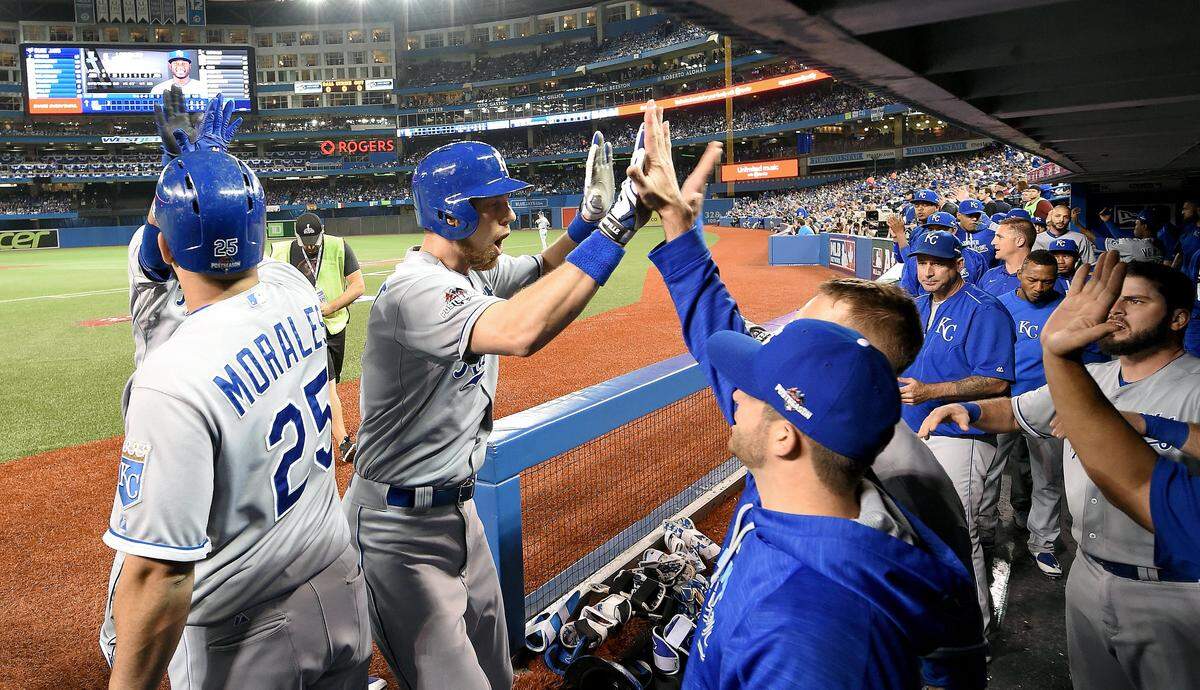 Kansas City Royals’ Ben Zobrist is congratulated after his two run home run in the first inning during Tuesday’s ALCS baseball game against the Toronto Blue Jays on October 20, 2015 at Rogers Centre, in Toronto.